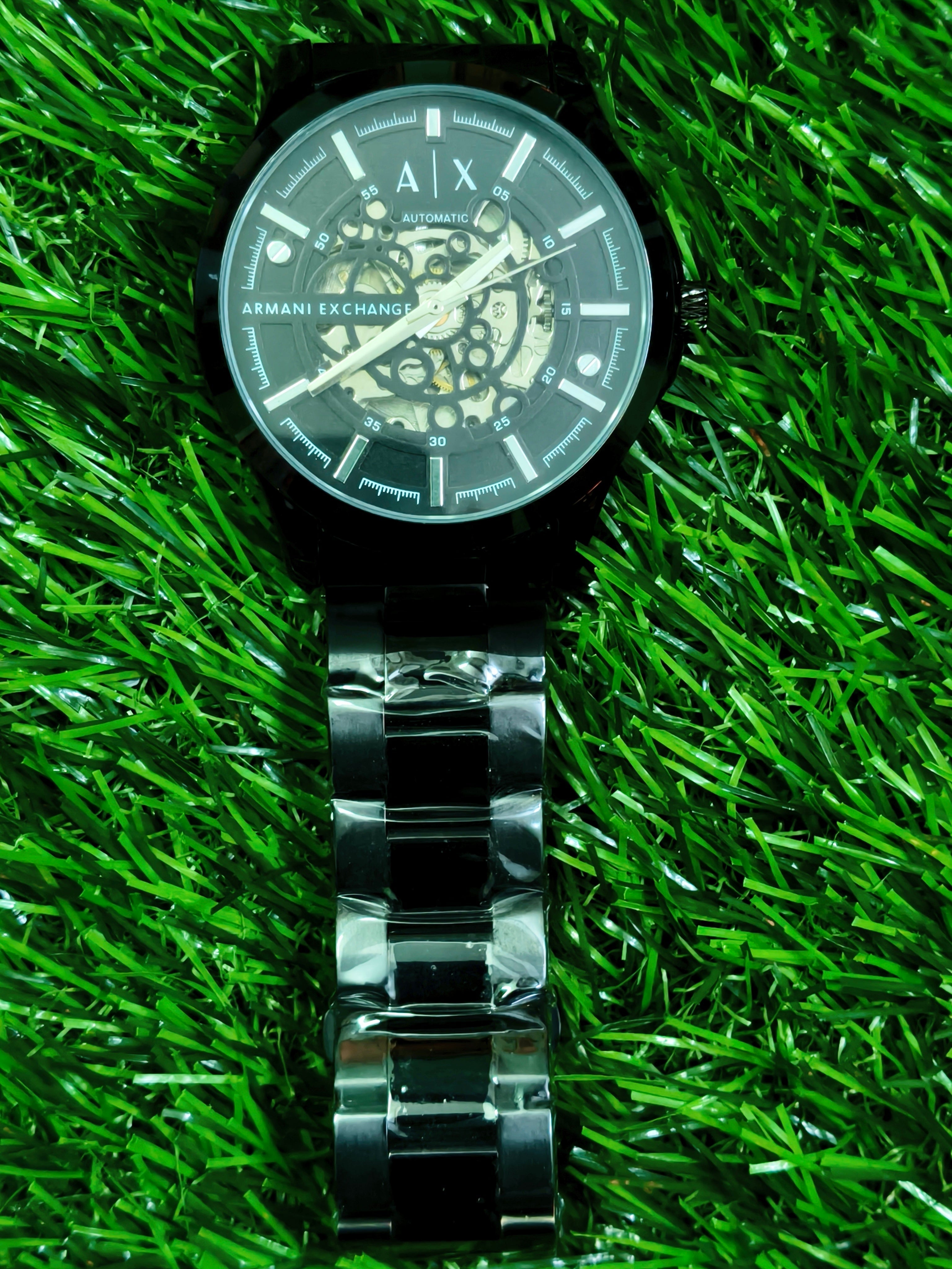 Fossil skeleton automatic watch with cushion-shaped silver case and dark open-worked dial
