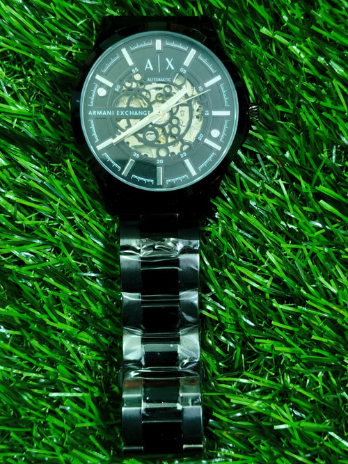 Fossil skeleton automatic watch with cushion-shaped silver case and dark open-worked dial