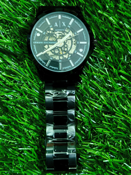 Fossil skeleton automatic watch with cushion-shaped silver case and dark open-worked dial